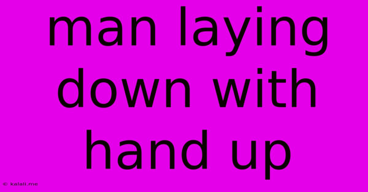 Man Laying Down With Hand Up